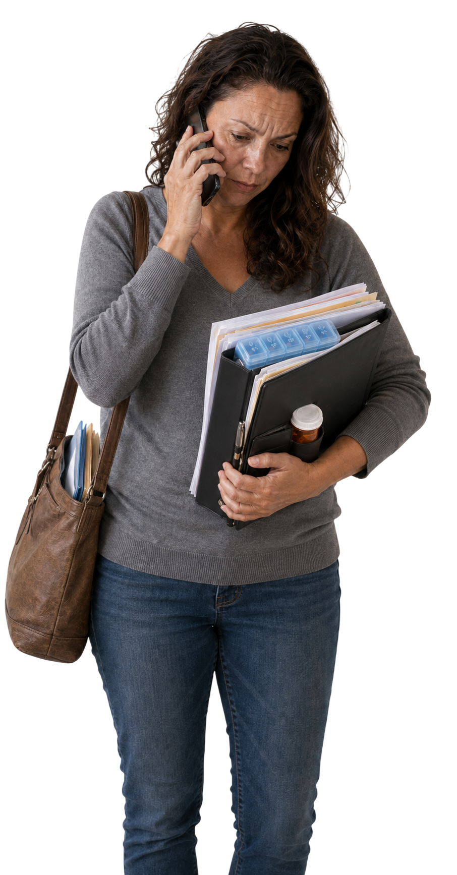 A woman on the phone, carrying a binder of paperwork, a pill organizer, and a prescription bottle